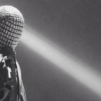 Masked rapper with his mic, in black and white